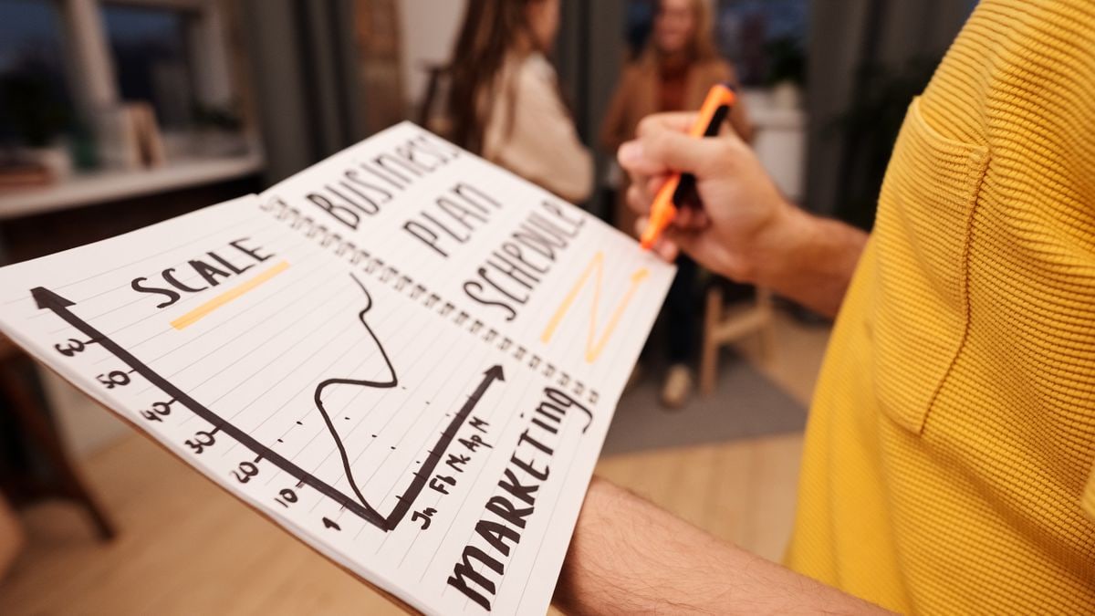 Close-up of a business notebook with marketing plans in a casual office environment.